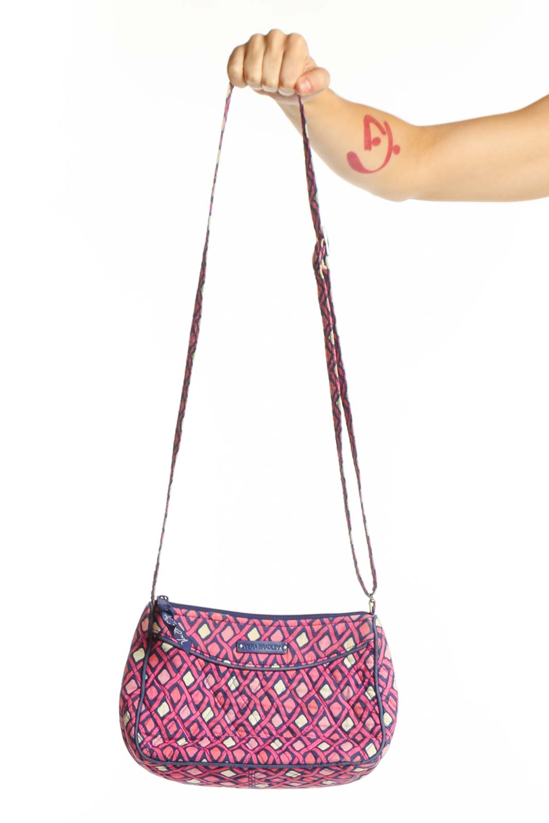 Pink and purple diamond quilted Vera Bradley crossbody bag with adjustable purple straps, shown being held
