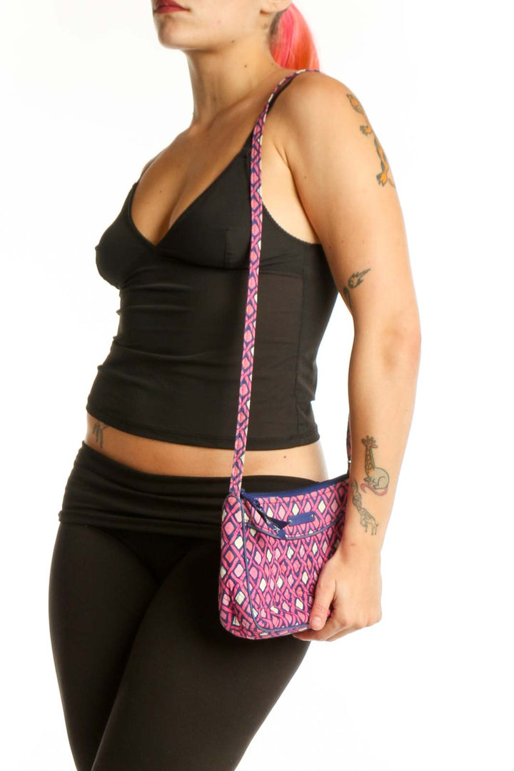Pink and purple diamond quilted Vera Bradley crossbody bag with adjustable purple straps, shown being held