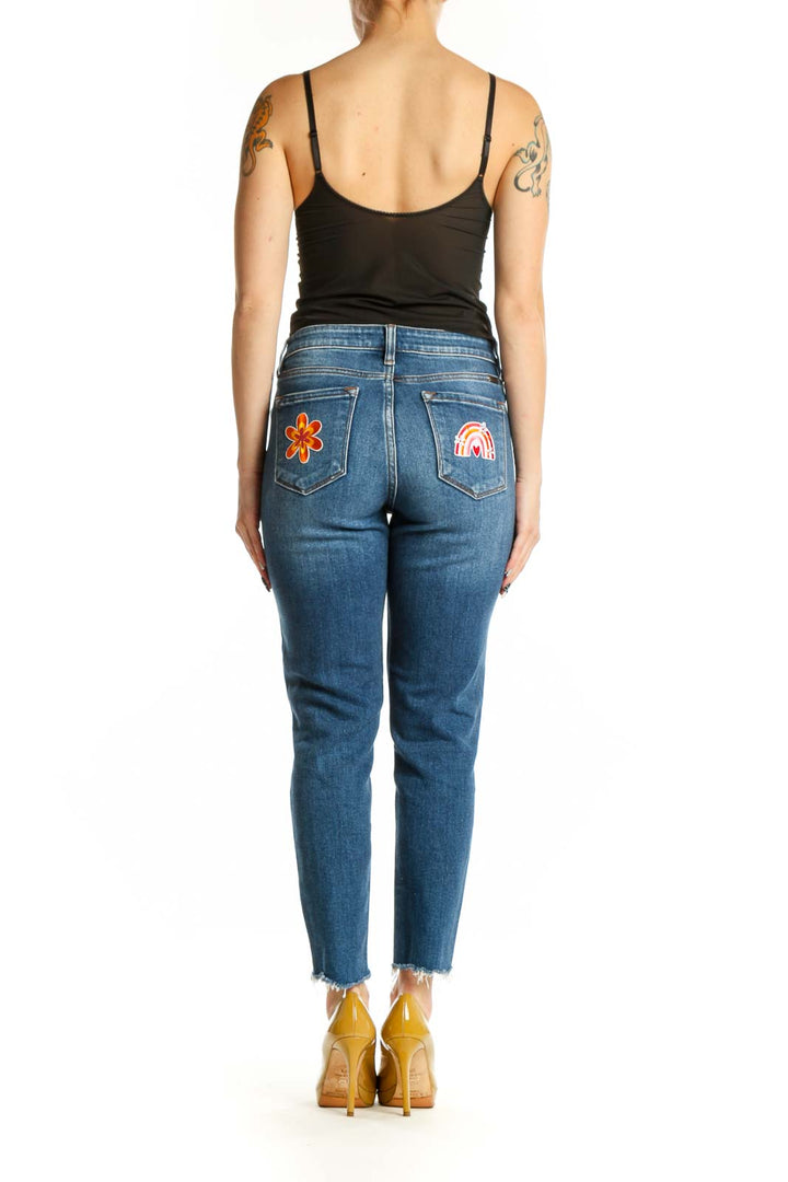 Back view of blue distressed skinny jeans with ripped knees by Kancan, showing classic five-pocket design