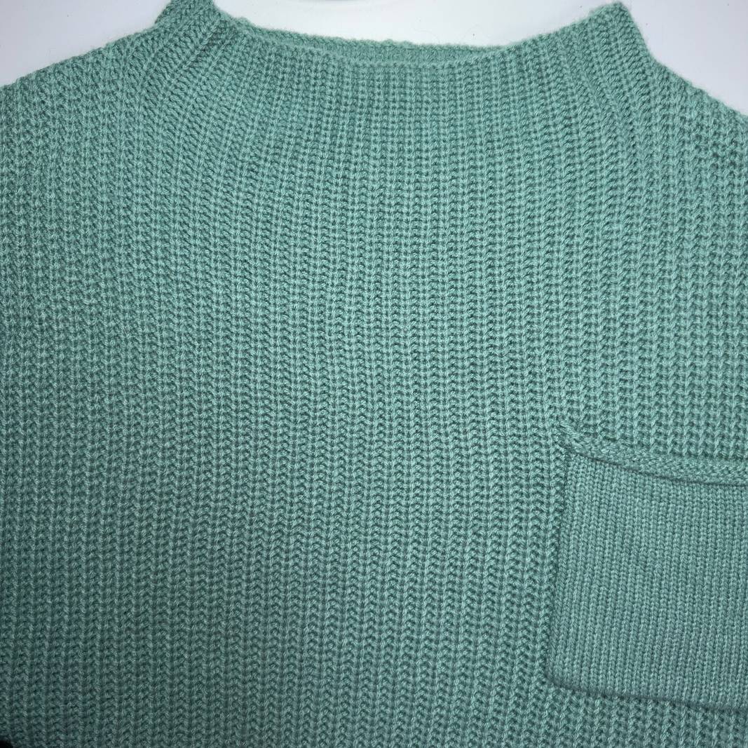 SilkRoll sage green ribbed knit short sleeve top, back view showing relaxed fit and pocket detail