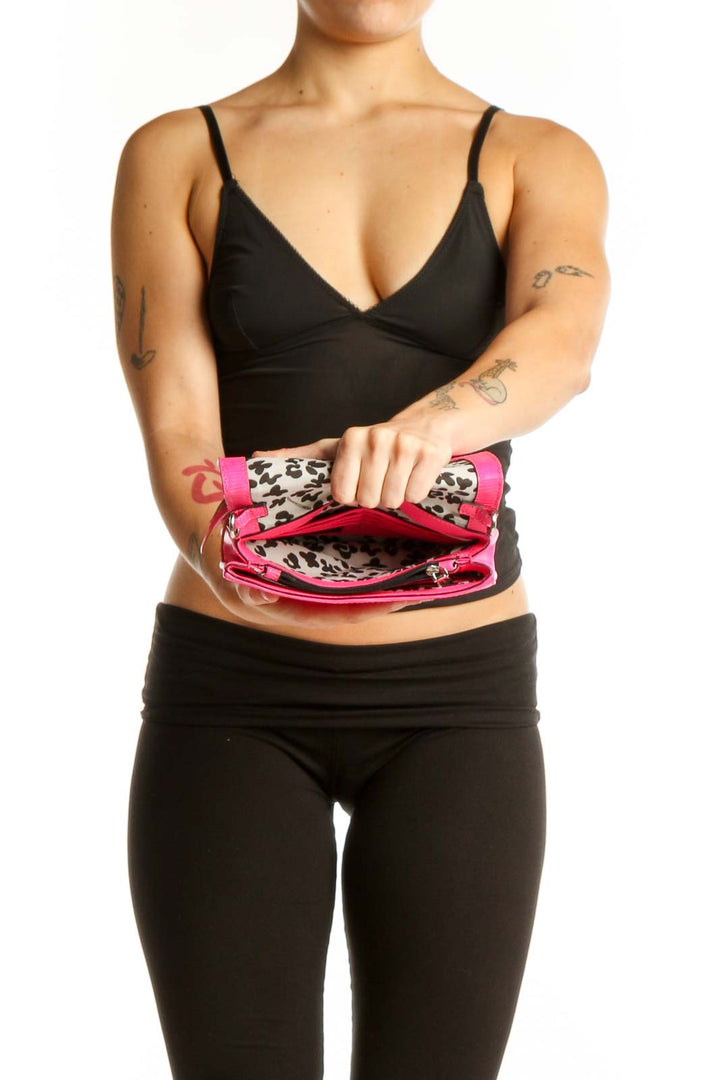 Back view of pink Rebecca Minkoff crossbody bag worn on shoulder with adjustable chain strap