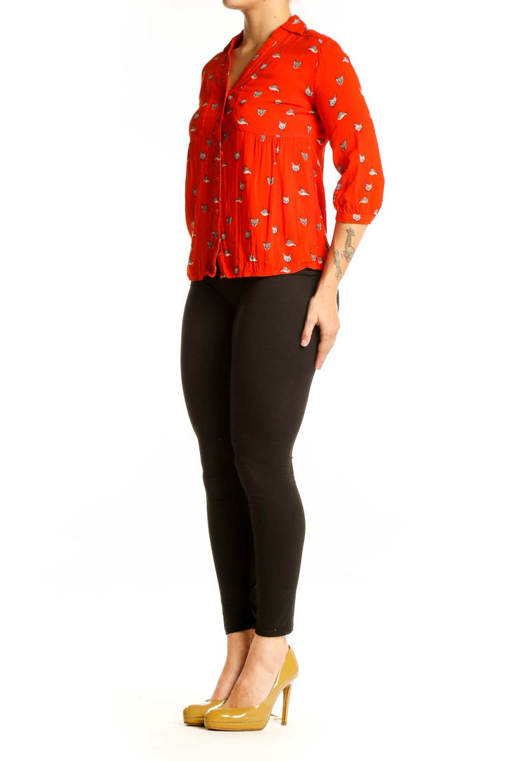 Red cat print button-up blouse with peplum waist detail, front view on model