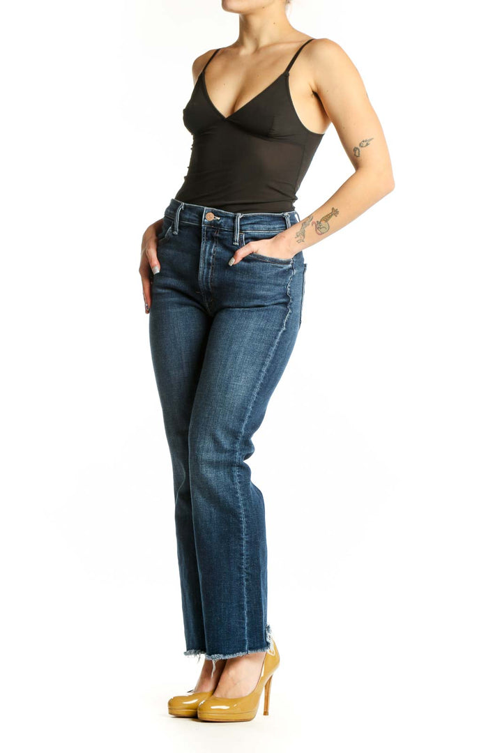 Front view of Mother blue cropped flare jeans with high-rise waist and raw frayed hem on model