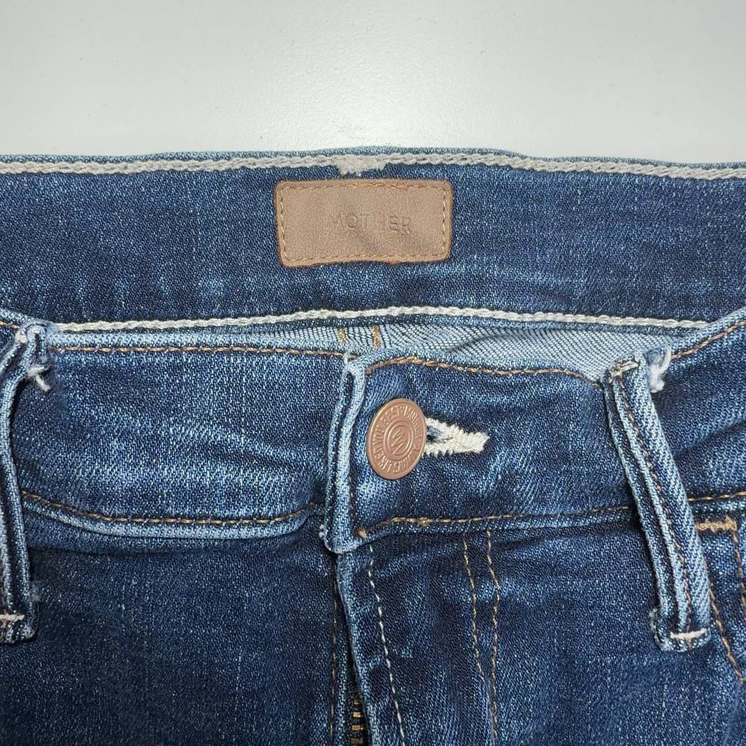 Tag view of Mother blue cropped flare jeans showing five-pocket design and flare silhouette