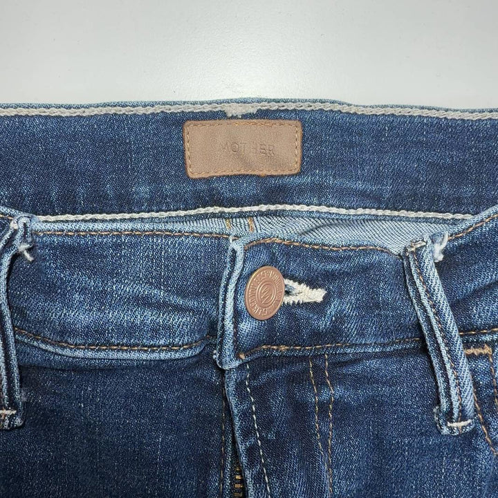 Tag view of Mother blue cropped flare jeans showing five-pocket design and flare silhouette