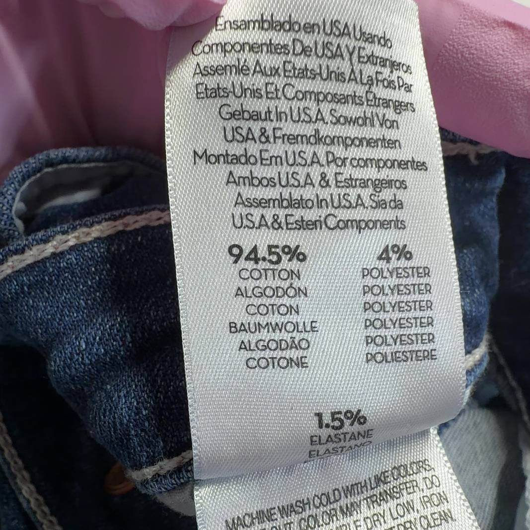 Tag view of Mother blue cropped flare jeans showing five-pocket design and flare silhouette