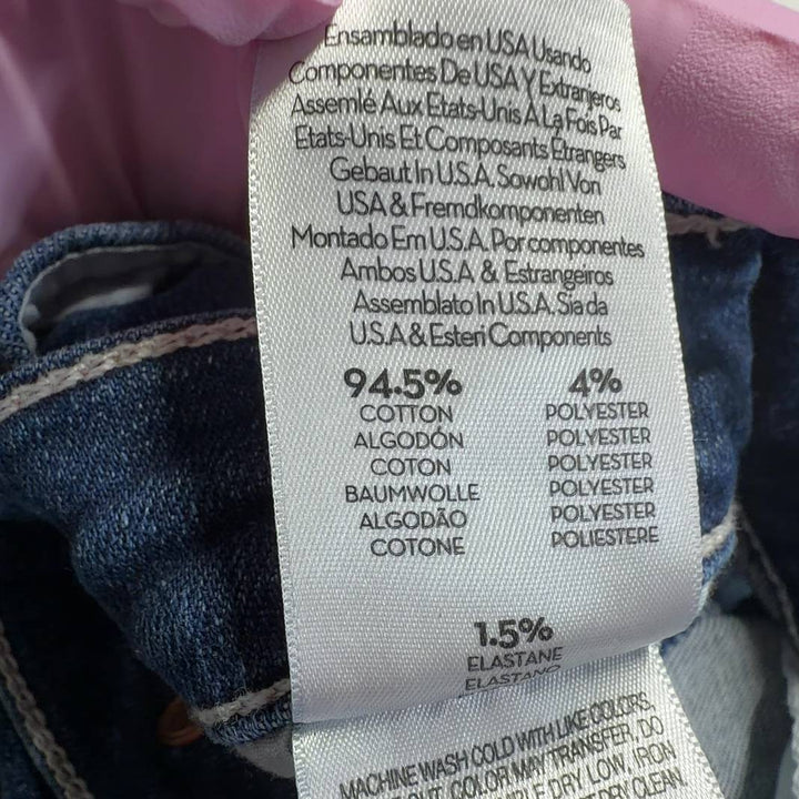 Tag view of Mother blue cropped flare jeans showing five-pocket design and flare silhouette