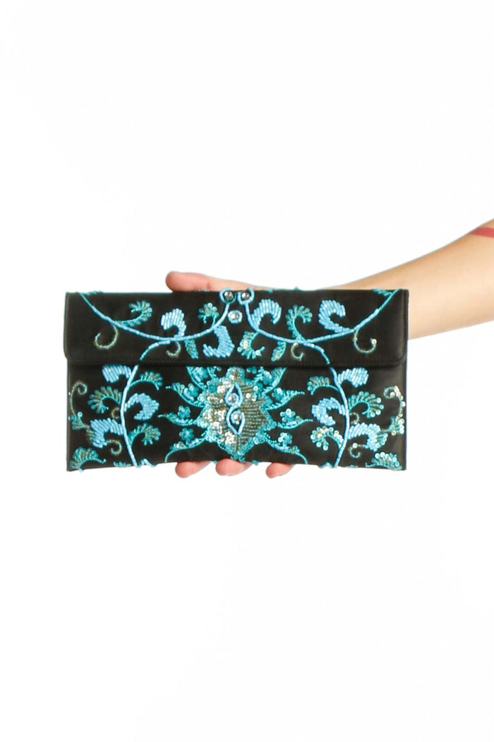 Black crossbody wallet with turquoise embroidered floral patterns and decorative beading by Valerie Stevens