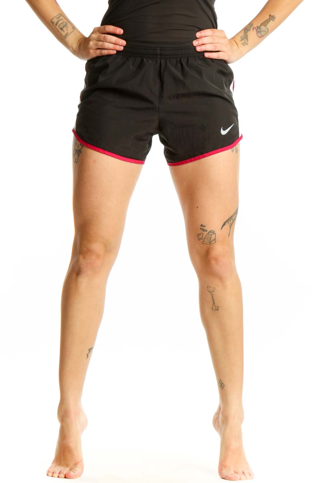 Black Nike athletic shorts with pink trim, front view showing elastic waistband and Nike Swoosh logo