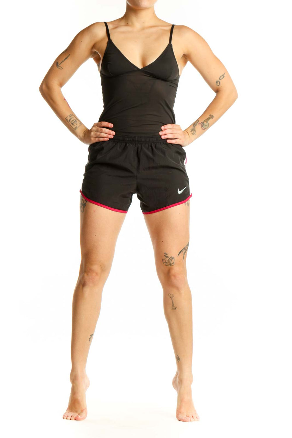 Black Nike athletic shorts with pink trim, front view showing elastic waistband and Nike Swoosh logo