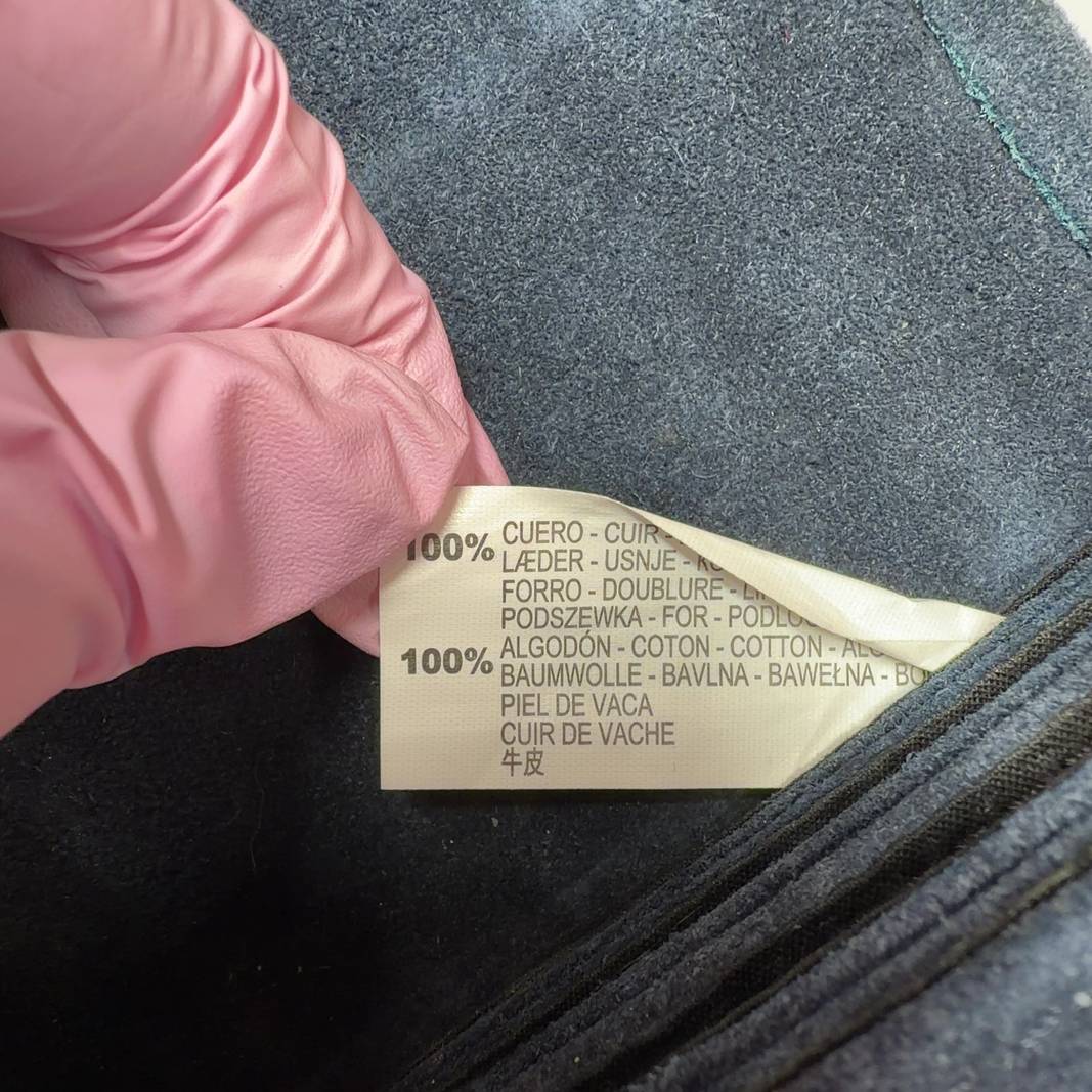 Teal cotton crossbody bag worn as crossbody style on model, showing back view and strap placement