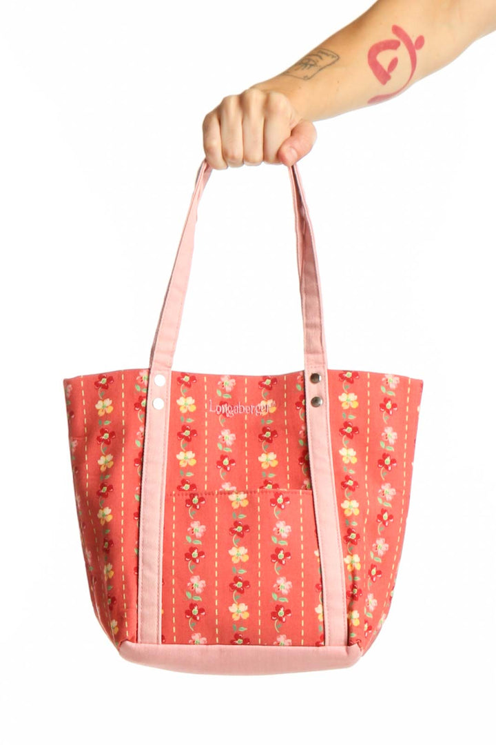 Red floral canvas Longaberger shoulder tote bag with pink handles, front view showing vibrant yellow and white flower pattern