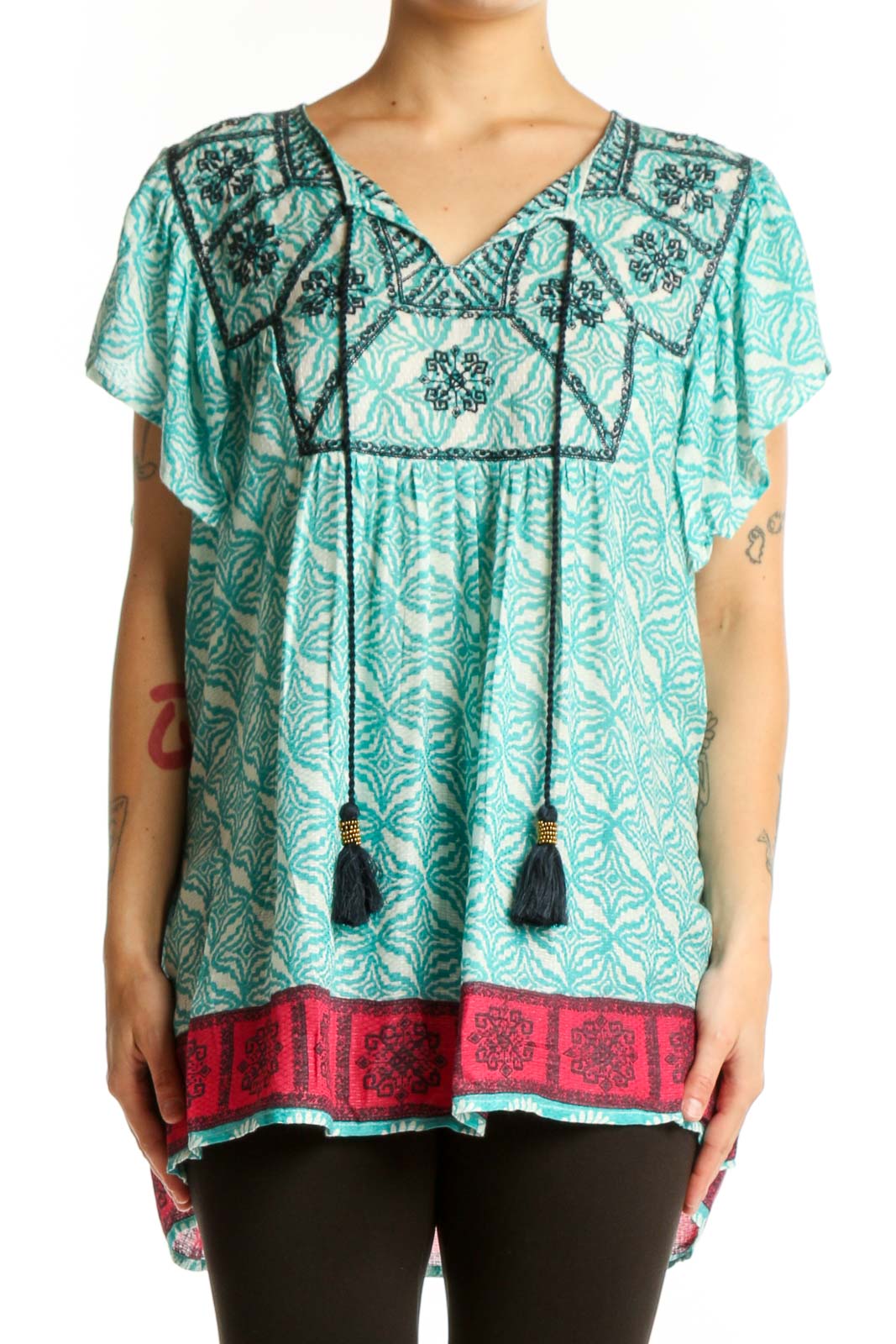 Rachel Zoe turquoise floral print tunic top with embroidered V-neckline and black tassel ties, worn with black leggings