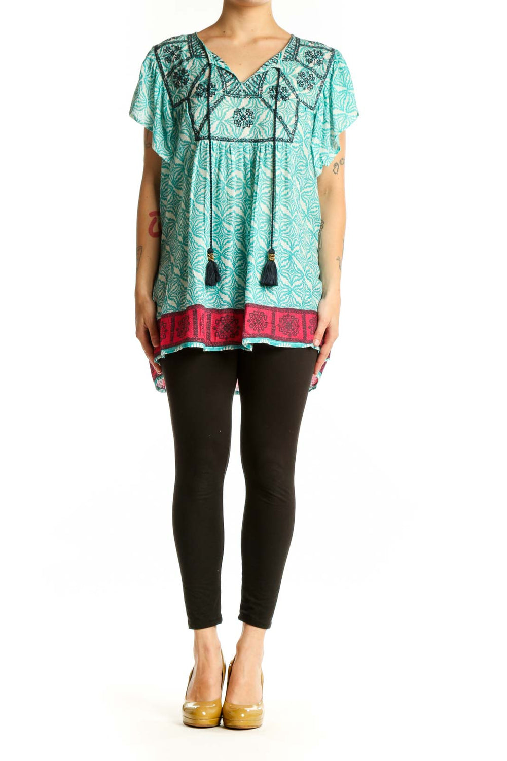 Rachel Zoe turquoise floral print tunic top with embroidered V-neckline and black tassel ties, worn with black leggings