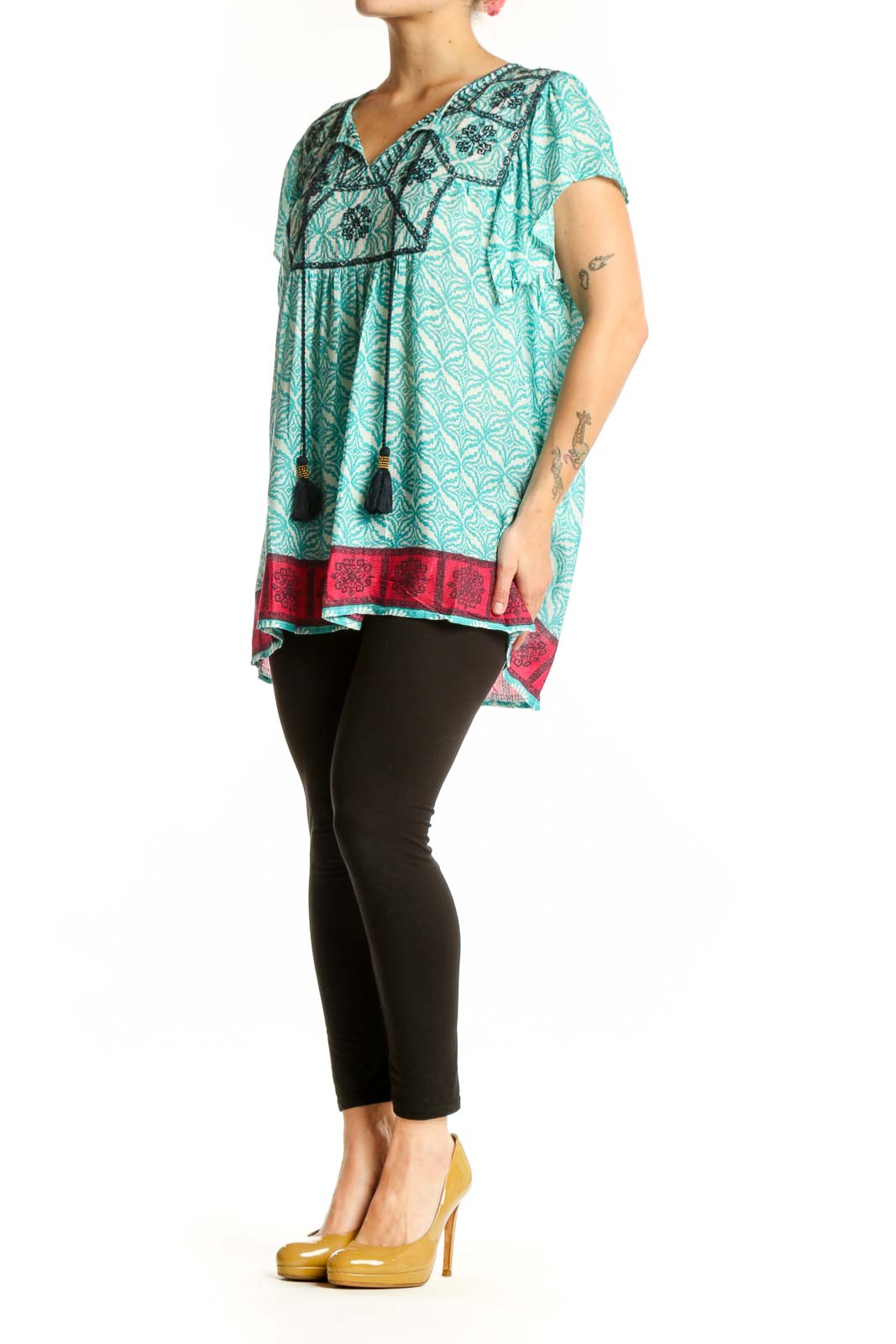 Rachel Zoe turquoise floral print tunic top with embroidered V-neckline and black tassel ties, worn with black leggings