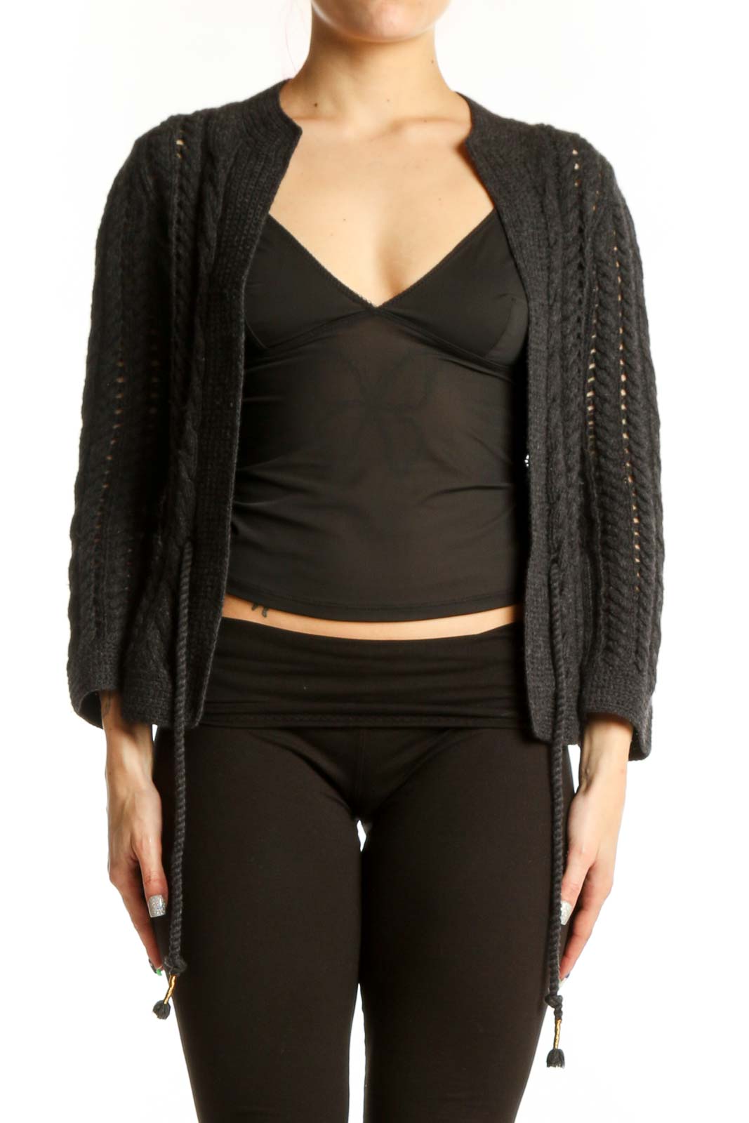 Charcoal cable knit cardigan with open front and tassel tie details, worn over black top