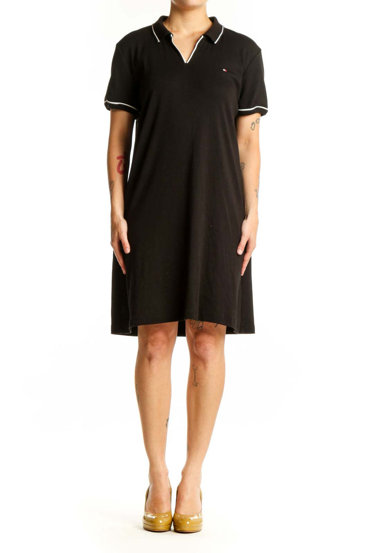 Black cotton polo shirt dress with white-tipped collar and short sleeves, front view