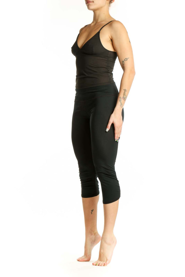 Black capri activewear leggings front view, high-waisted design with form-fitting silhouette