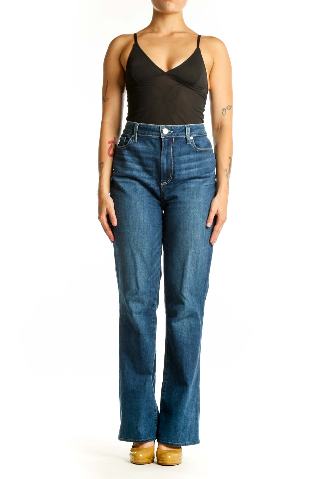 Woman wearing blue high-waisted flare denim jeans by Paige, front view