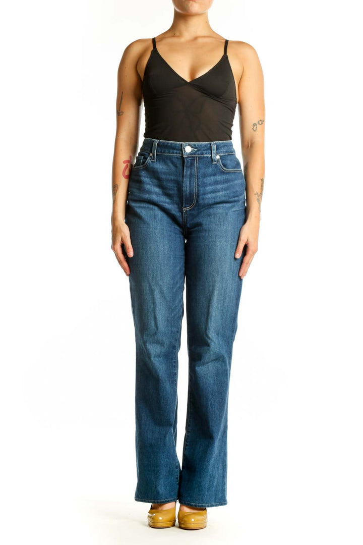 Woman wearing blue high-waisted flare denim jeans by Paige, front view