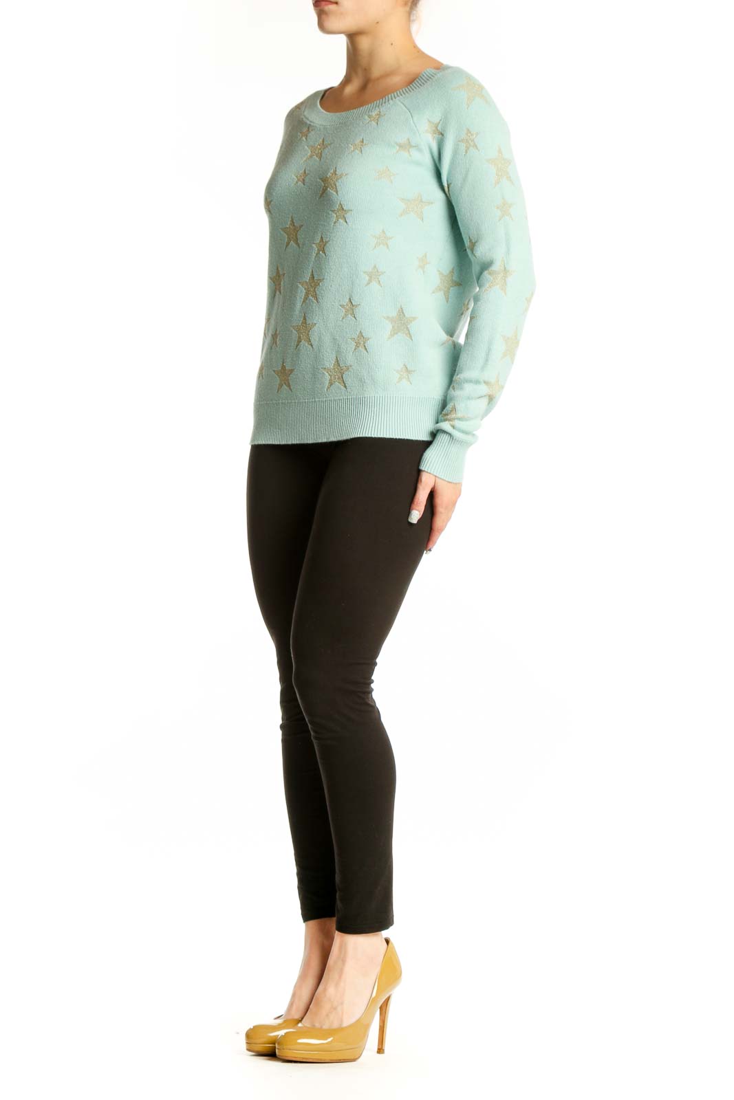 Mint green knit sweater with gold star pattern, front view on model wearing black pants