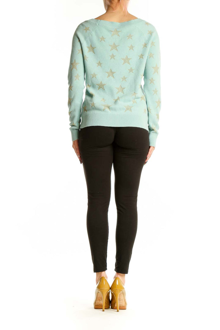 Mint green star pattern sweater, back view on model showing relaxed fit and design