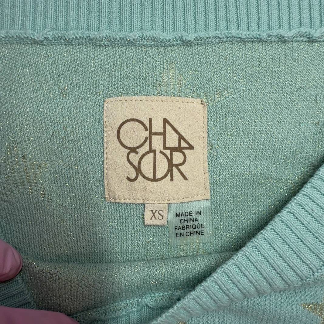 Mint green star pattern sweater, back view on model showing relaxed fit and design