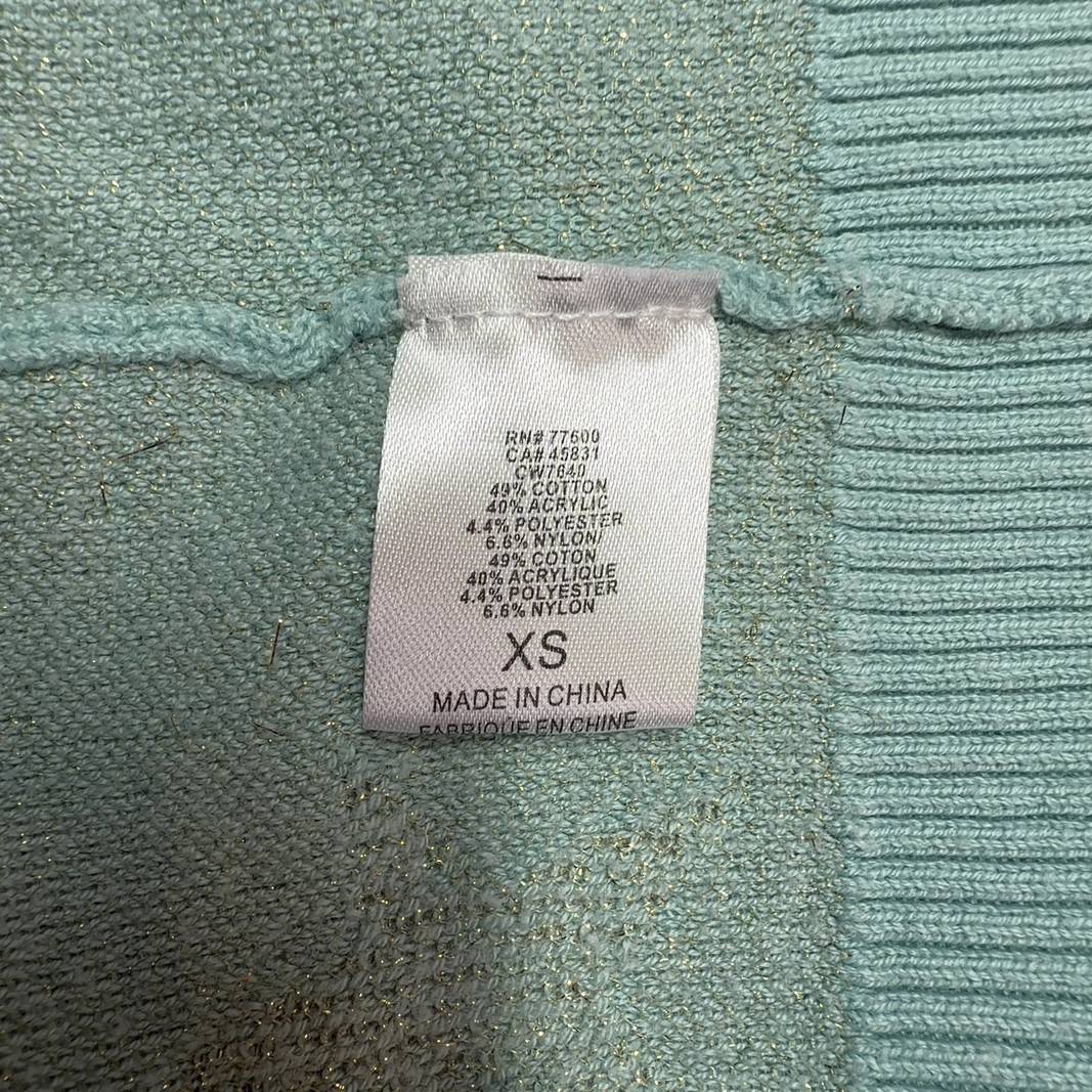 Mint green star pattern sweater, back view on model showing relaxed fit and design