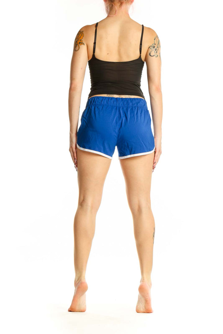 Back view of blue Adidas athletic shorts showing side profile and white contrast piping detail