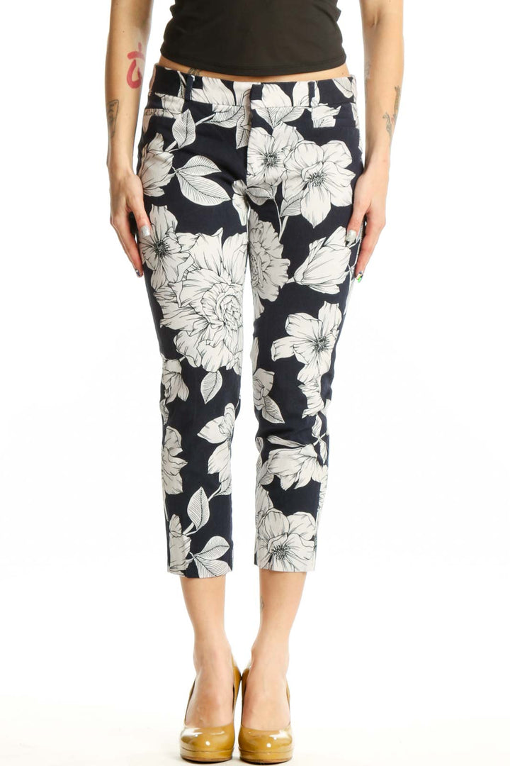 Navy floral cropped capri pants with white botanical print, front view on model
