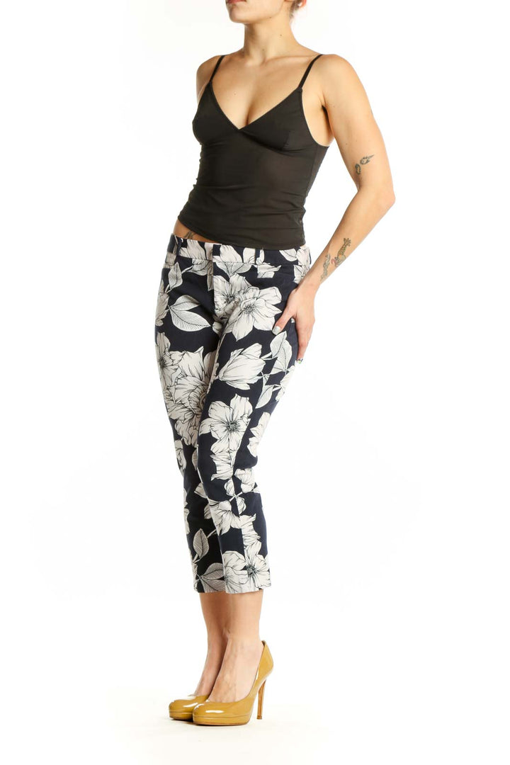 Navy floral cropped capri pants with white botanical print, front view on model