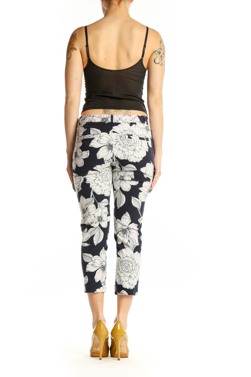 Navy floral cropped capri pants with white botanical print, back view on model