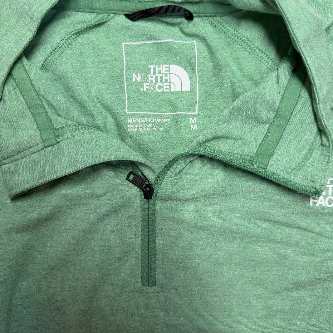 Sage green The North Face quarter-zip pullover back view, showing relaxed fit and long sleeves