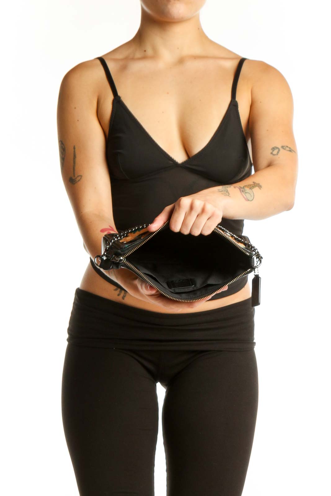 Coach multicolor floral shoulder bag worn as crossbody bag on model wearing black outfit