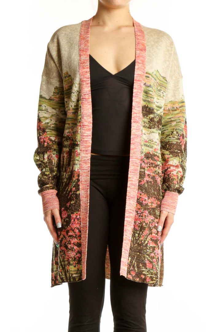 Multicolor floral cardigan with metallic accents and pink ribbed trim worn over black top, front view