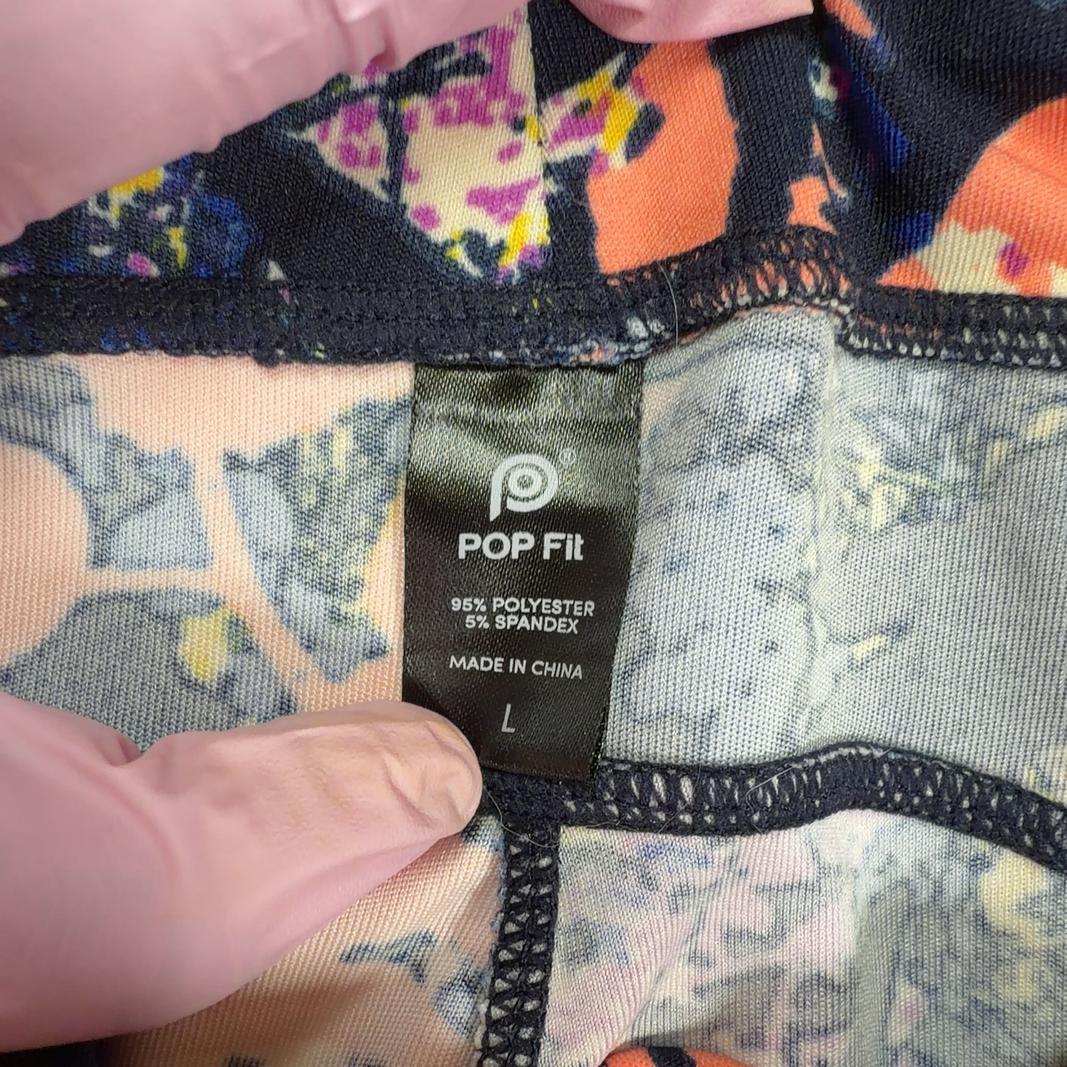 Navy floral print Pop Fit activewear leggings back view, showing full-length fit and colorful floral pattern