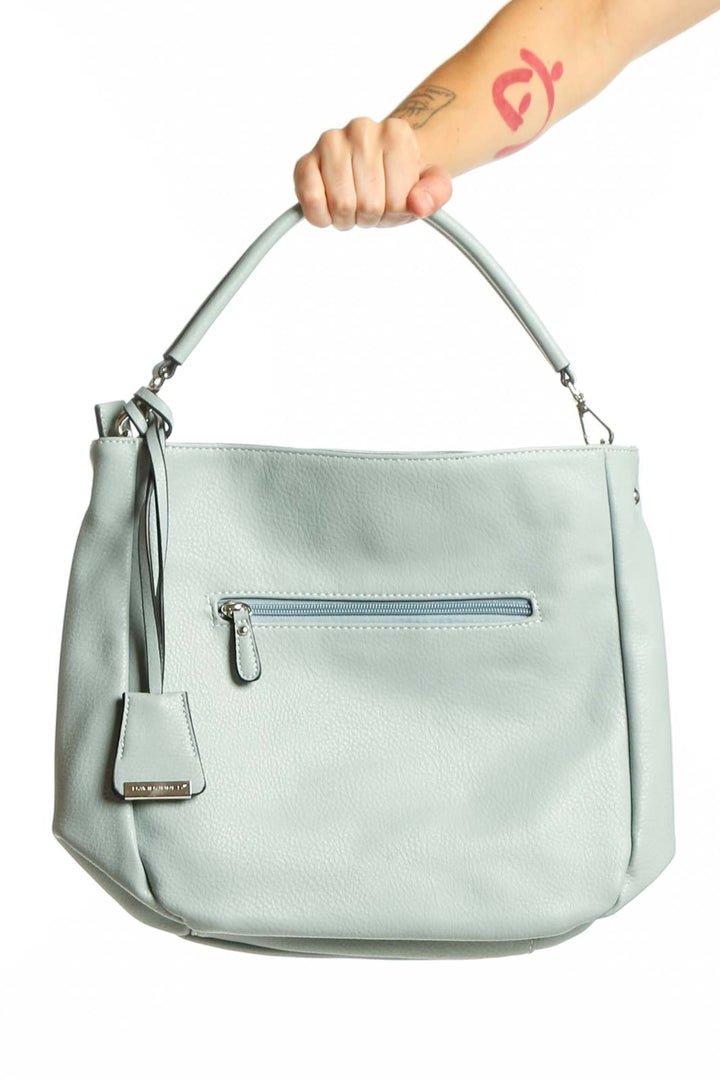 Sage green crossbody bag by David Jones Paris with adjustable strap and front zip pocket, held by hand