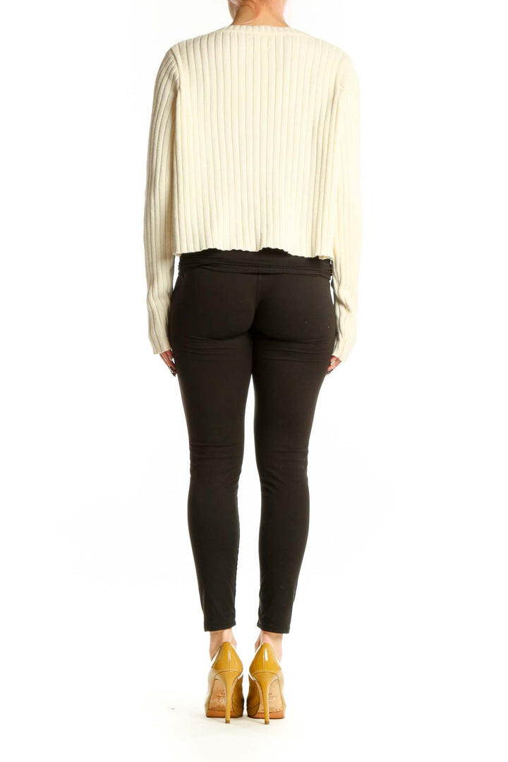 Back view of cream ribbed knit cropped cardigan showing textured knit pattern and cropped length