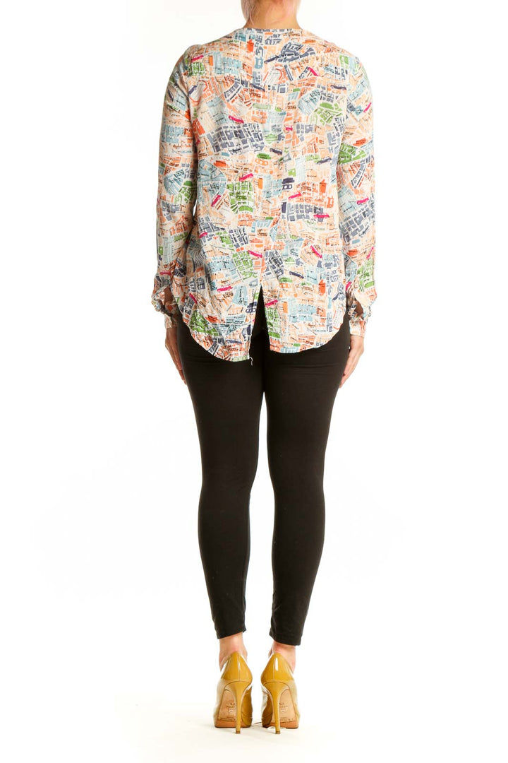Back view of multicolor newspaper print rayon blouse by Mango showing peplum hem detail and relaxed fit