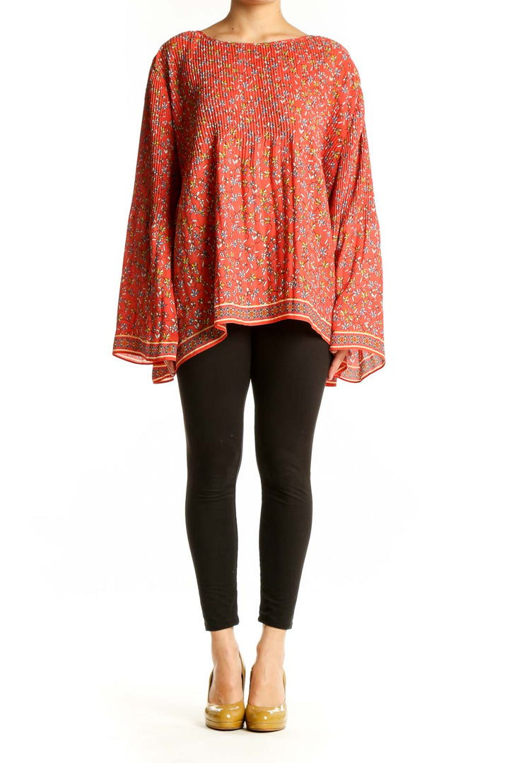 Red floral pleated cape top by Max Studio, front view showing vibrant floral pattern and flowing silhouette