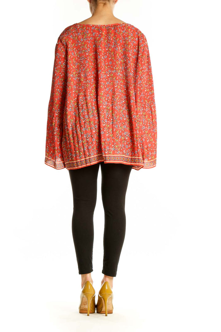 Red floral pleated cape top by Max Studio, back view displaying pleated detailing and decorative border trim