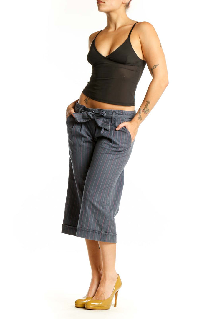 Gray pinstriped cropped shorts with tie-waist detail, front view on model