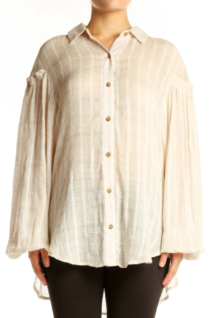 Free People cream button-up blouse with voluminous bell sleeves and striped texture, front view