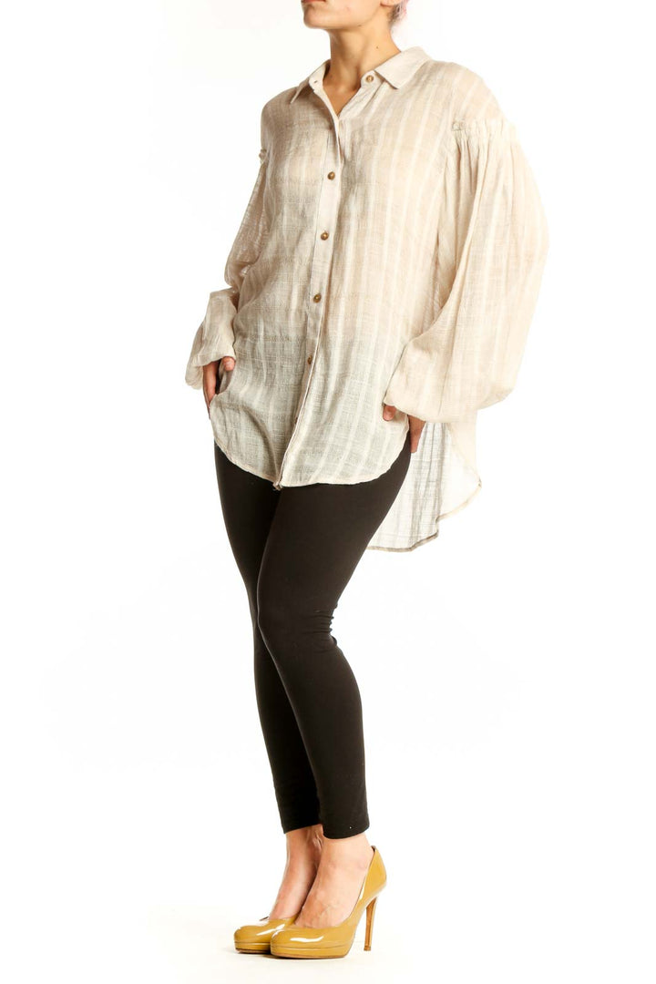 Free People cream button-up blouse with voluminous bell sleeves and striped texture, front view