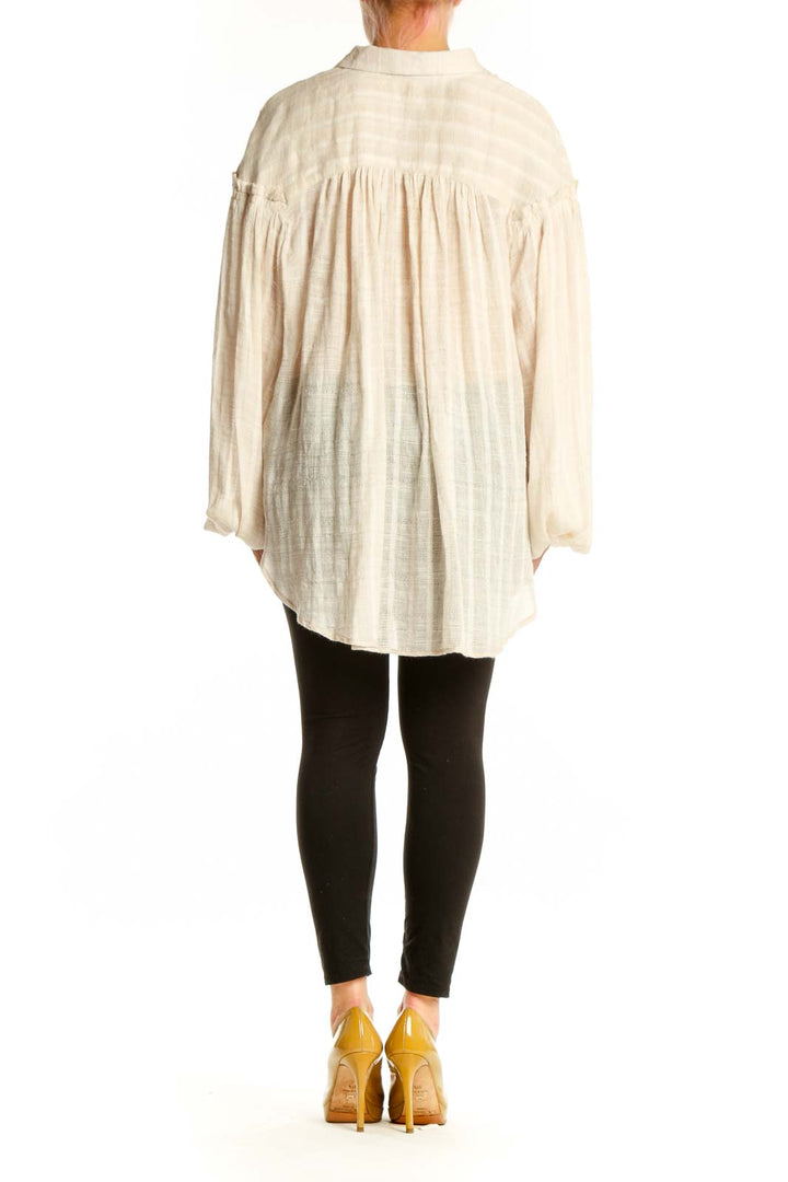 Free People cream button-up blouse with voluminous bell sleeves, back view showing relaxed oversized fit