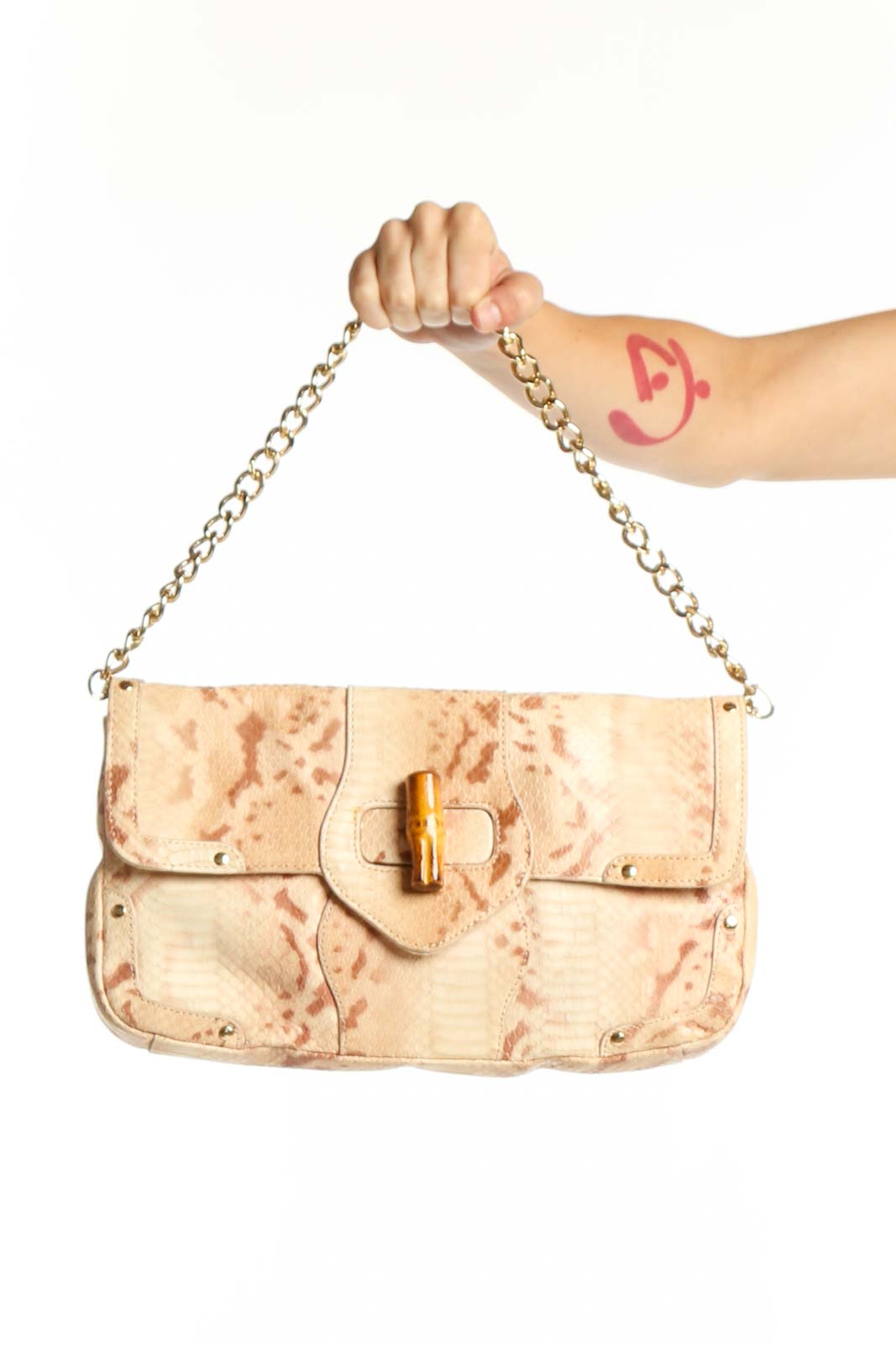 Cream velvet Elaine Turner shoulder bag with dual gold chain straps and bamboo clasp closure, held by hand