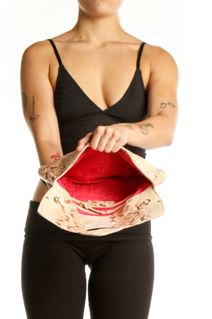 Back view of cream velvet Elaine Turner shoulder bag worn as shoulder bag, showing structured silhouette and chain strap detail