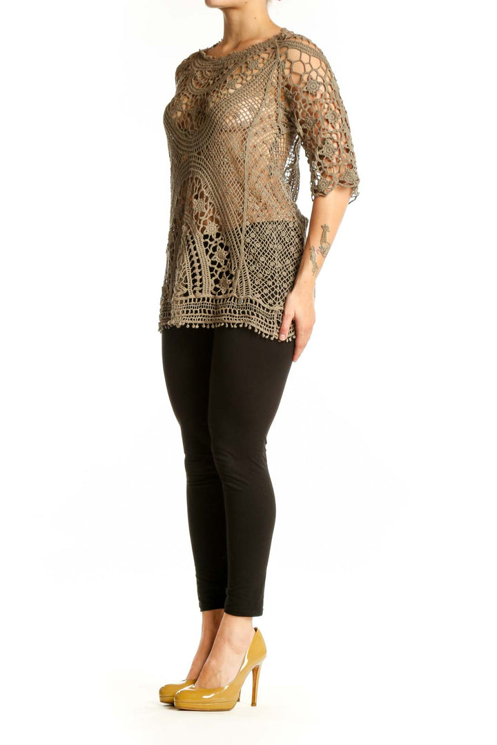 Beige crochet lace knit top with intricate open-weave pattern and three-quarter sleeves, front view