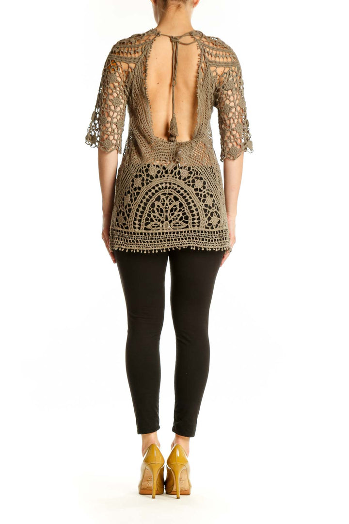 Beige crochet lace knit top with geometric lacework design, back view