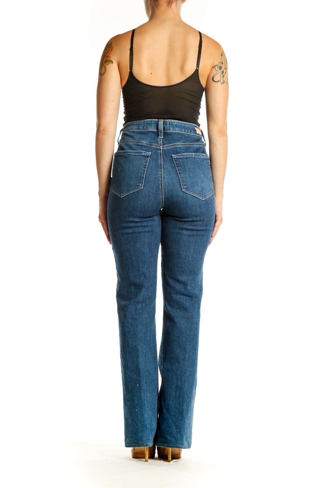 Back view of Paige blue flare jeans highlighting the high-waisted silhouette and flattering fit on size L